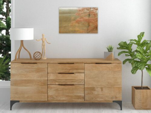 A photograph of landscape in motion above a wooden sideboard