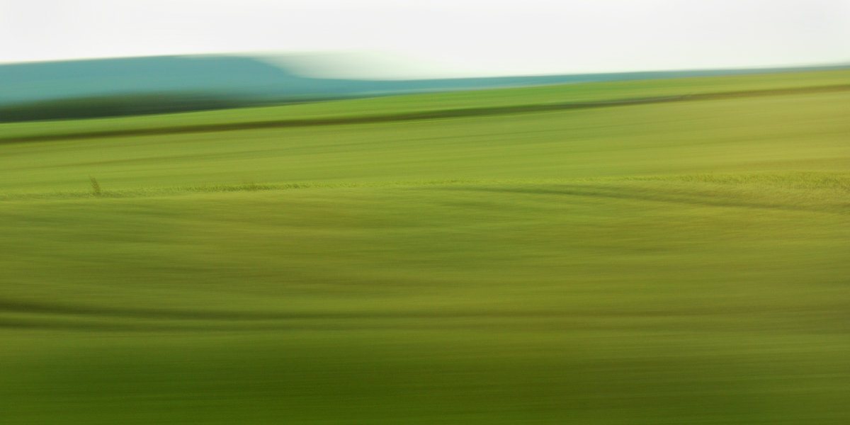 experimental photo art, a field turned into soft waves by motion blur