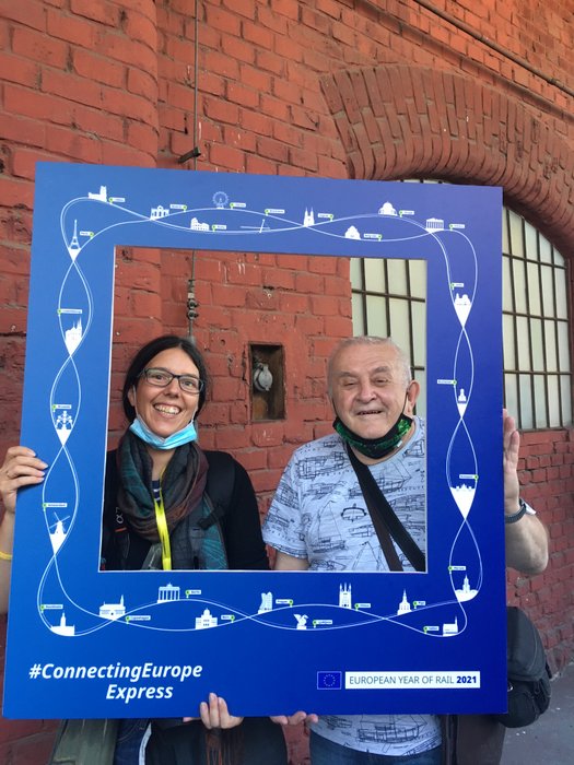 Jennifer Scales and a Slovakian photographer look through a frame with the design of the Connecting Europe Expess