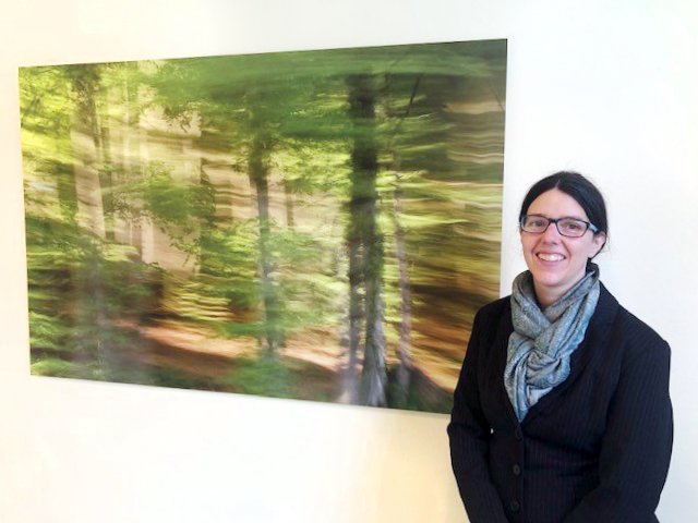 Jennifer Scales in front of a large format landscape photograph