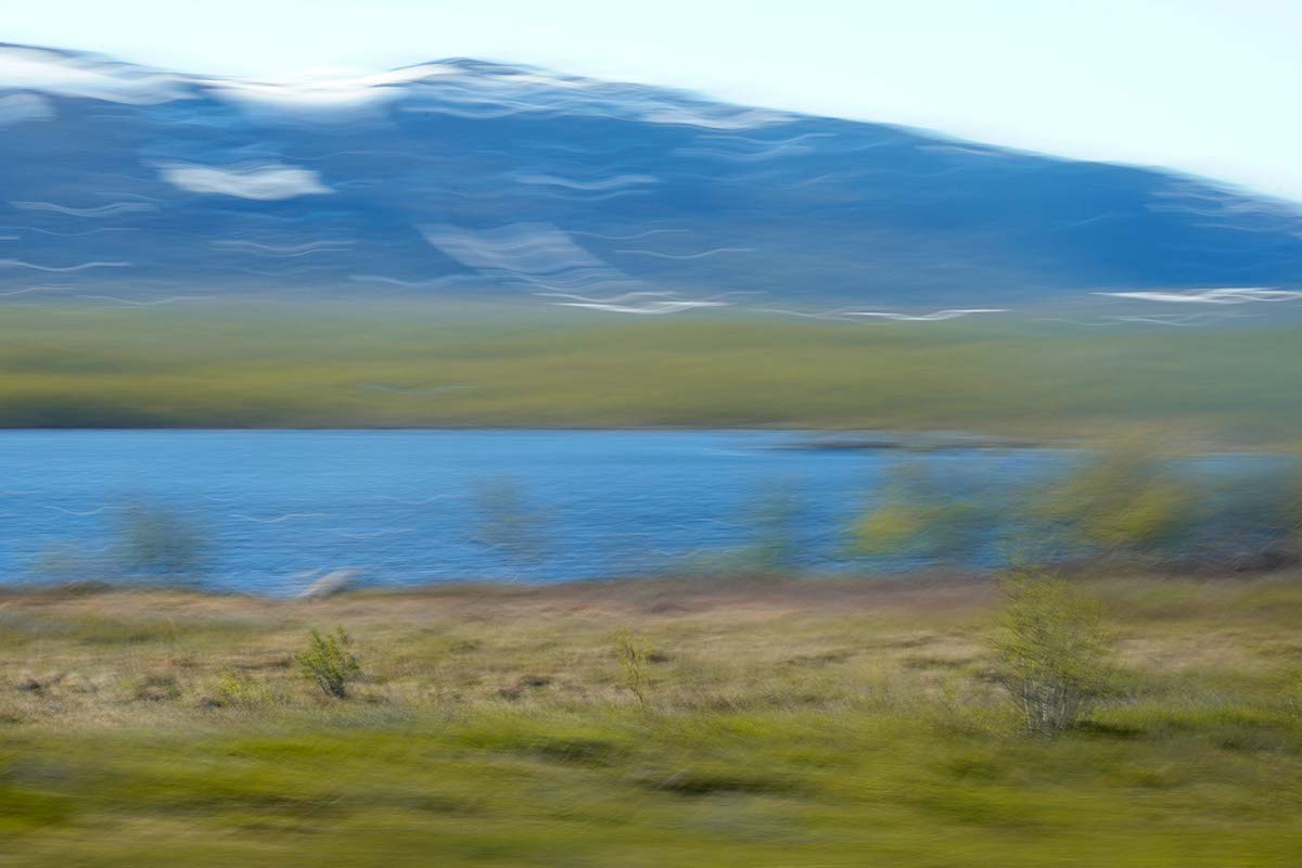 Lake, bushes and a snowy mountain in the background - Swedish landscape in motion - ICM photography by Jennifer Scales
